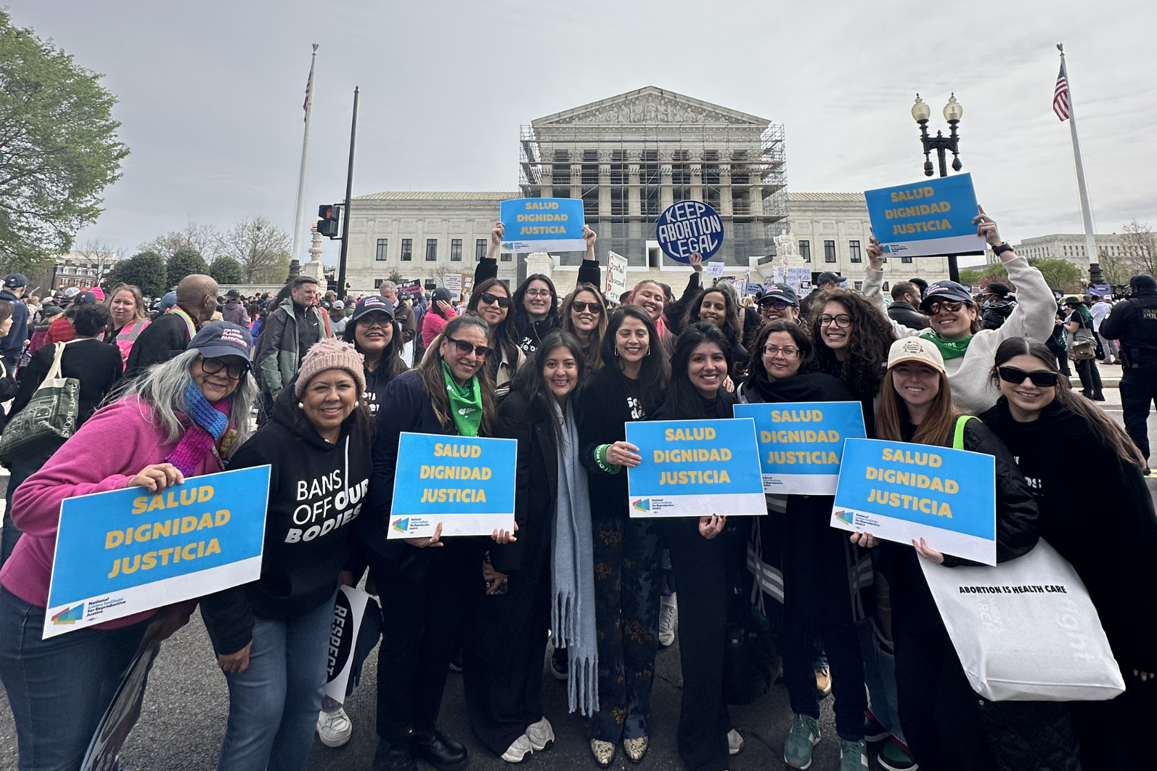 Latina Institute advocates holding “Salud Dignidad Justicia” signs outside the U.S. Supreme Court at a reproductive justice rally