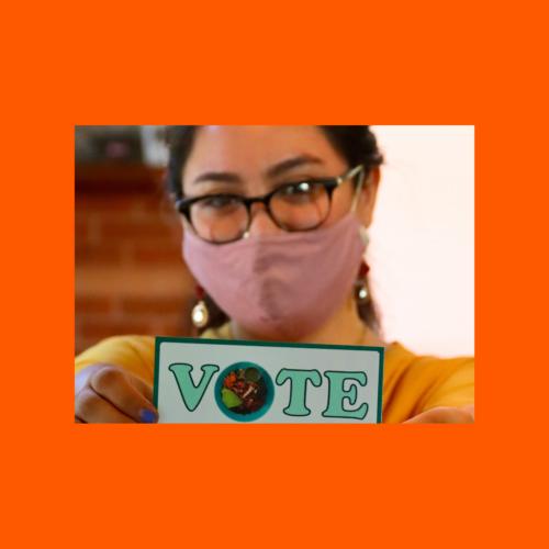 Closeup image of a woman holding white and green card reading, 