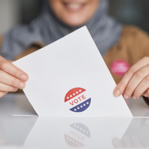 Close up photo of a woman's hands holding a ballot.